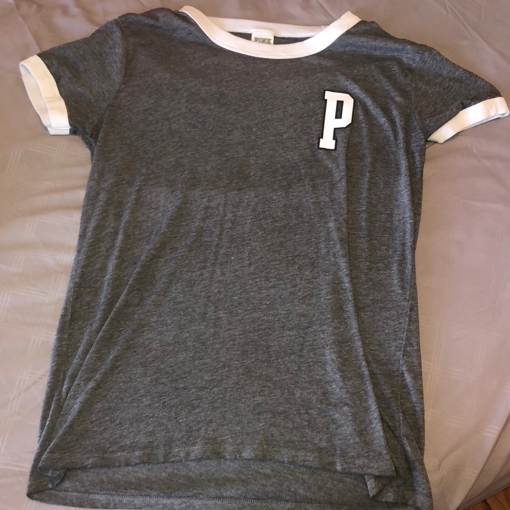 A grey shirt from PINK ,white trim around the arms